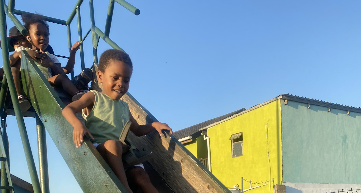 Children playing joyfully on the slide