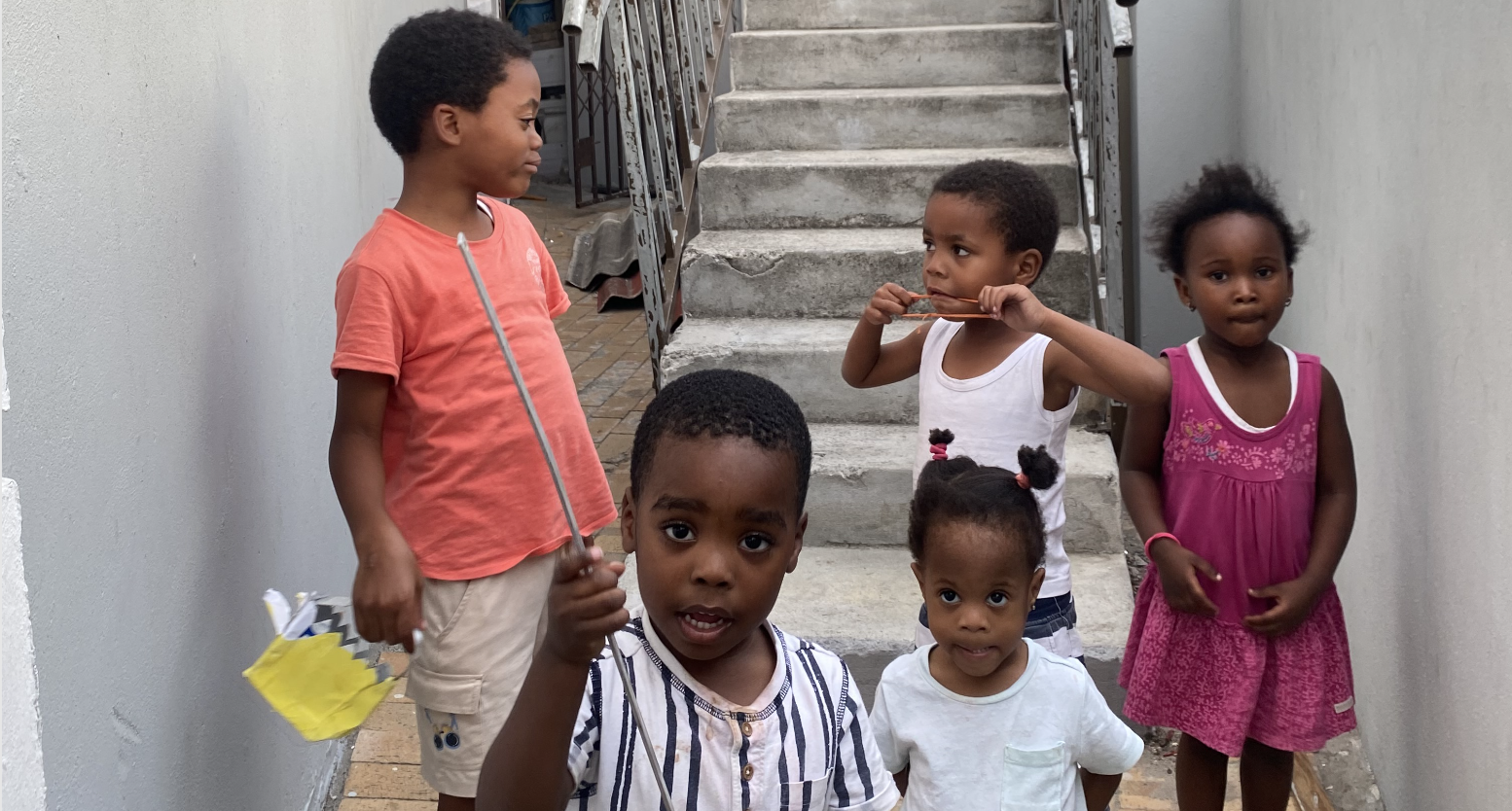 Children gathered on the stairs at the foundation home