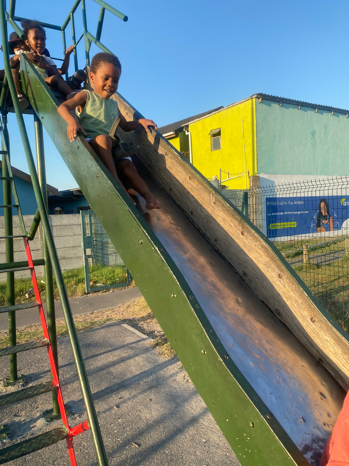Children playing together on a slide